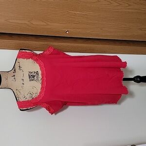 2x red tank top with lace trip and a small ruffle hem.